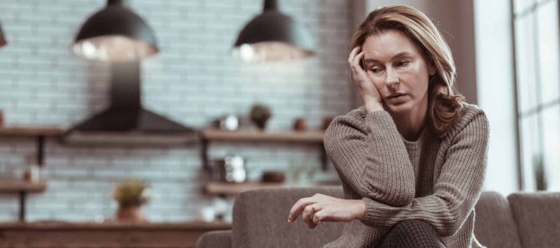Woman wondering what causes her sleep deprivation