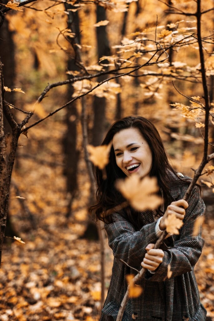 Autumn Anxiety, Mental Health. Happy brunette woman enjoy life in autumn forest