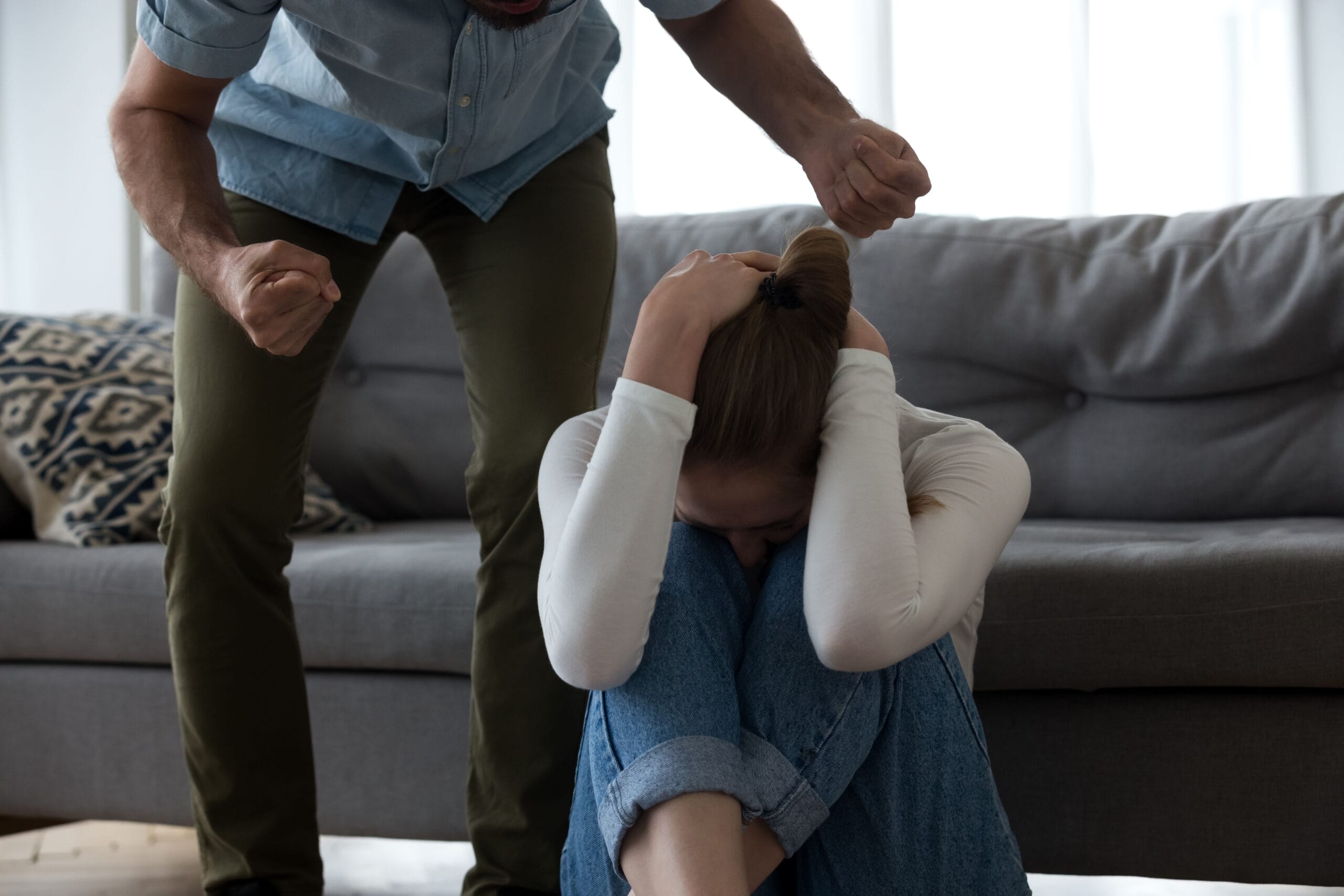 Signs of Anger Issues with Man angrily standing over a scared woman.