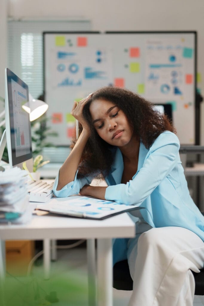 Exhausted office worker taking a break from work, feeling tired and stressed from overworking